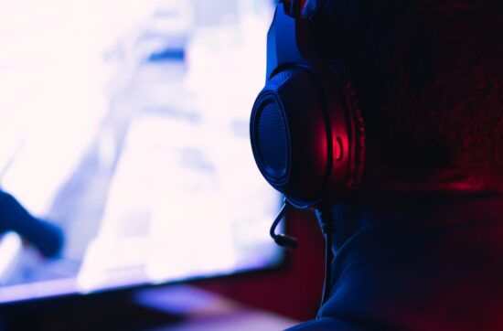 man in red shirt wearing black headphones